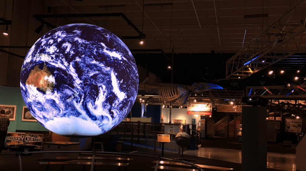 A glowing digital orb displaying the earth